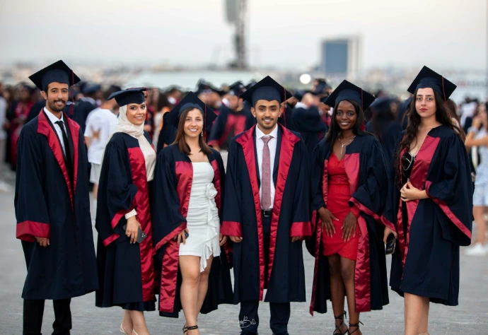 A group of people in graduation gowns posing for a picture